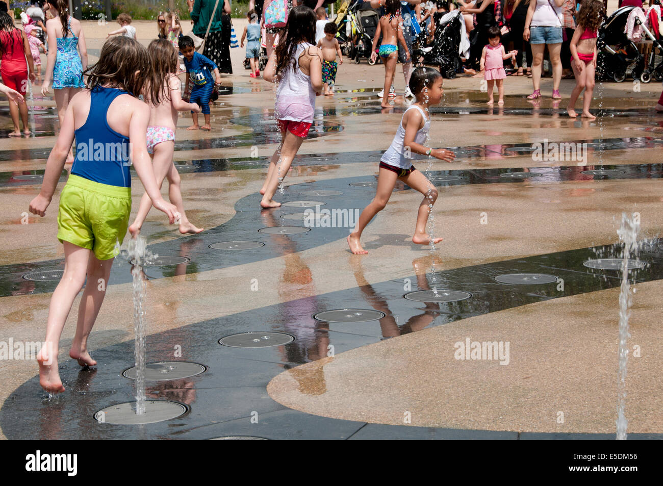 London July 2014. Playing in the fountains, Queen Elizabeth Park, Stratford Stock Photo