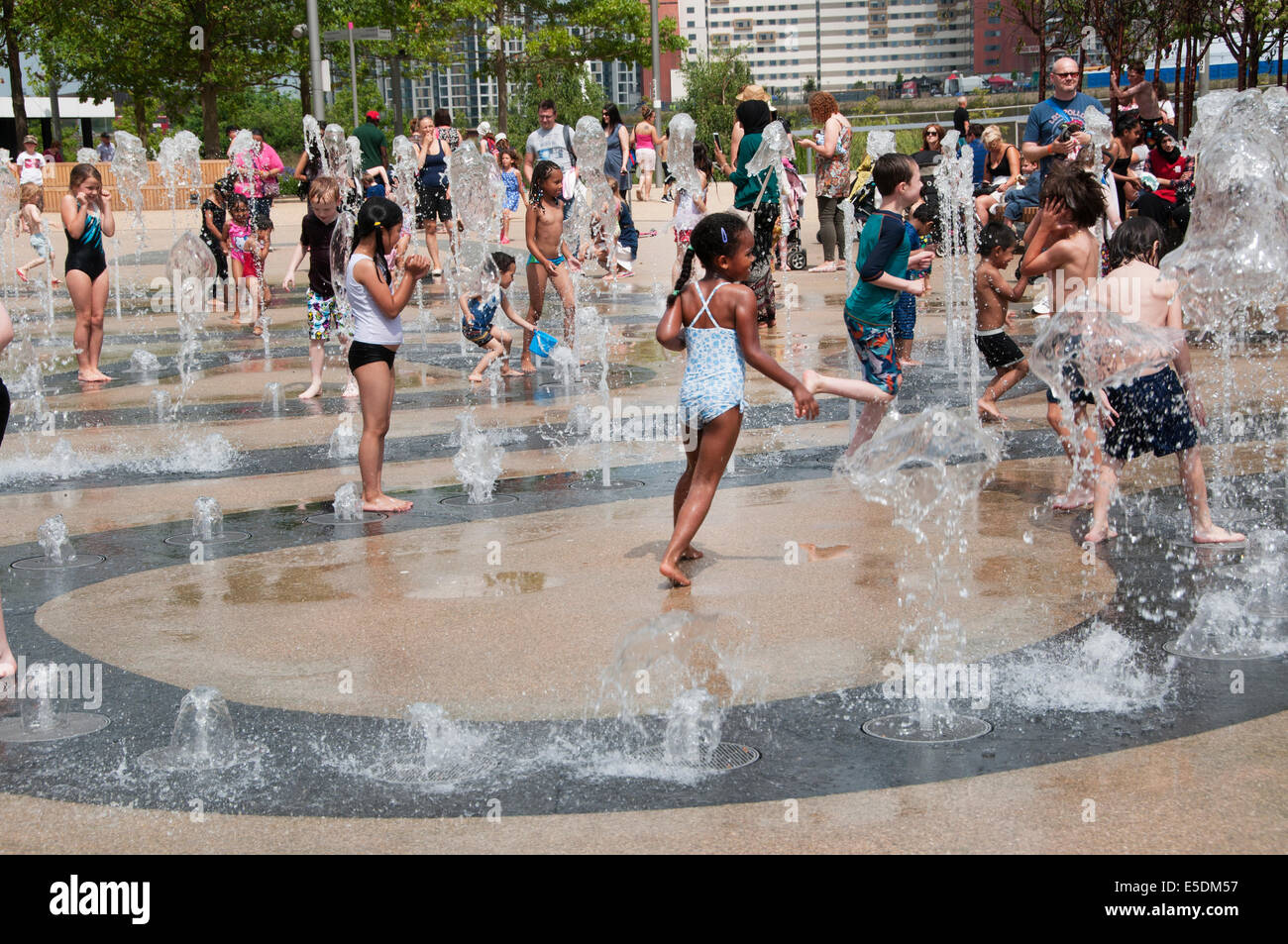 London July 2014. Children playing in the fountains, Queen Elizabeth Park, Stratford Stock Photo