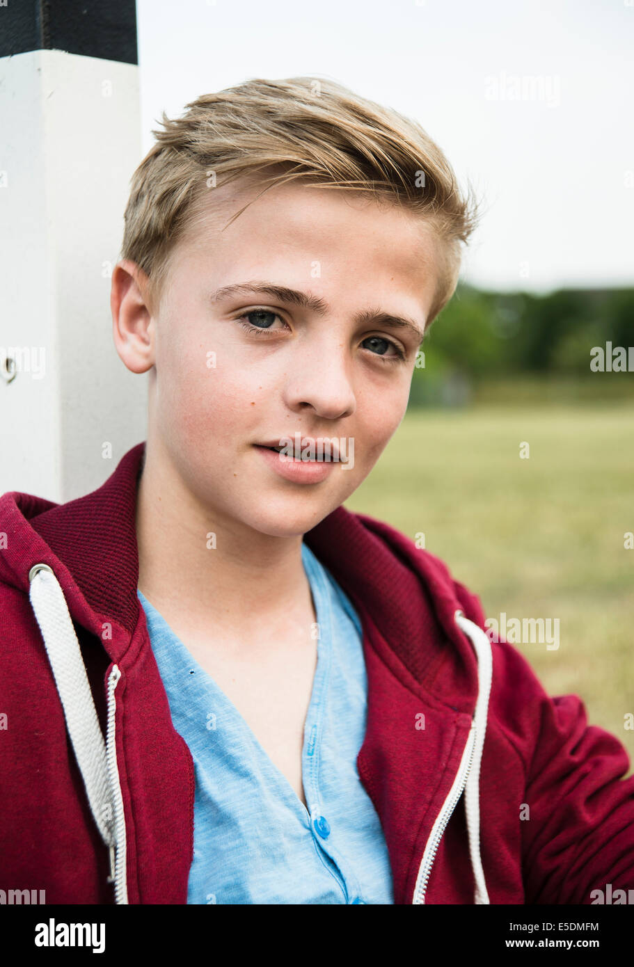 Teenage boy leaning on goal post hires stock photography and images