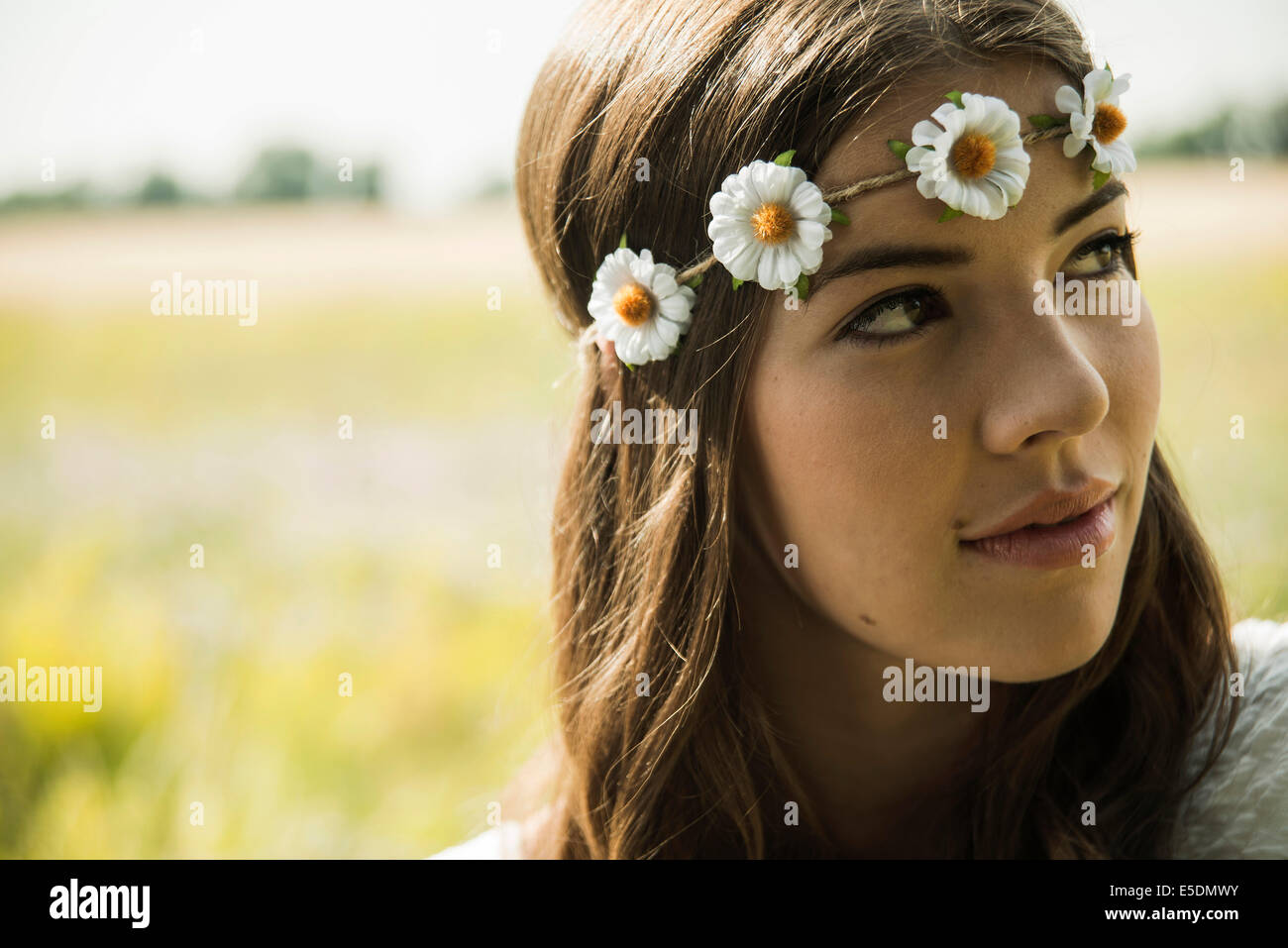 Portrait of young woman wearing floral wreath Stock Photo - Alamy