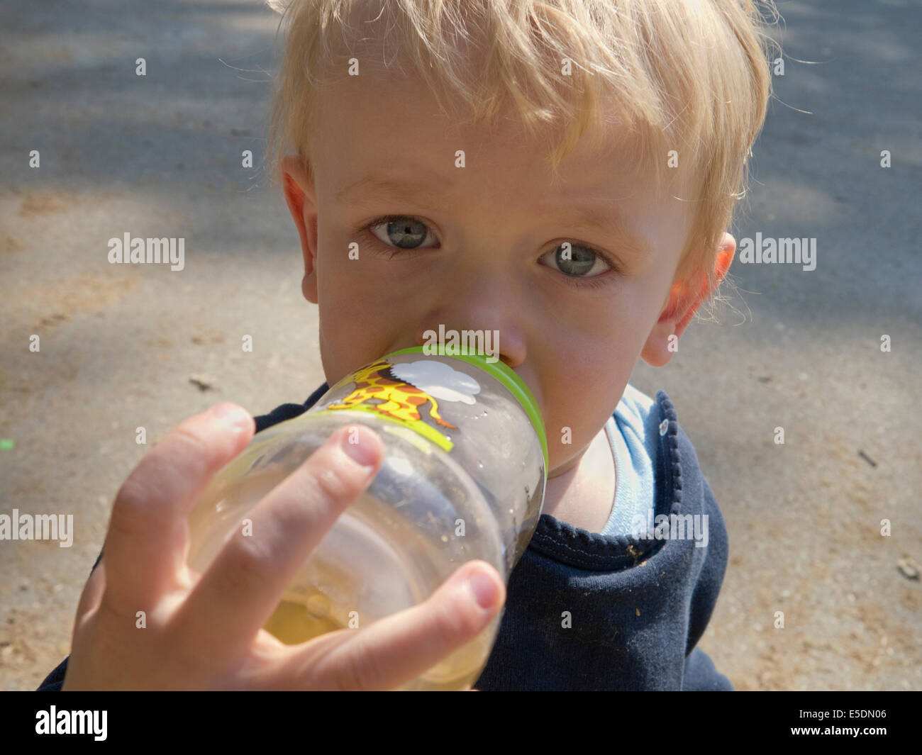 Baby boy drinking from bottle Stock Photo