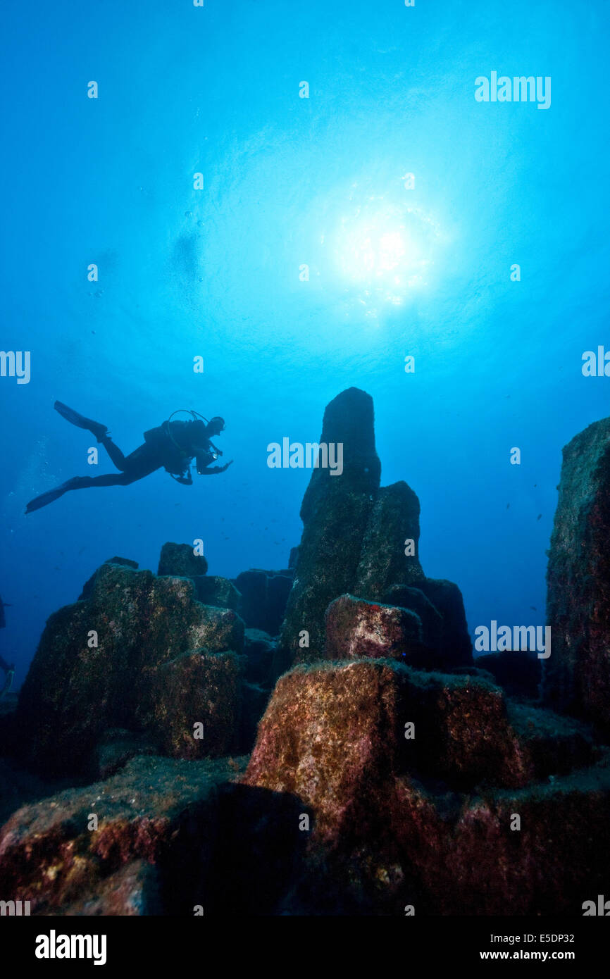 Portugal, Azores, Santa Maria, Atlantic Ocean, diver at volcanic basalt ...