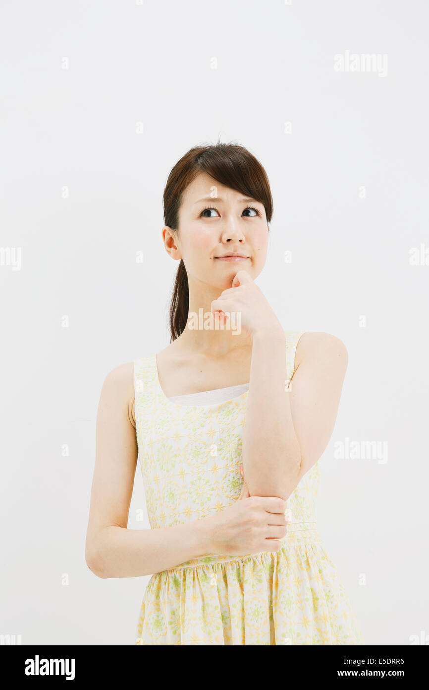 Japanese young woman in a one piece dress standing against white background Stock Photo Alamy