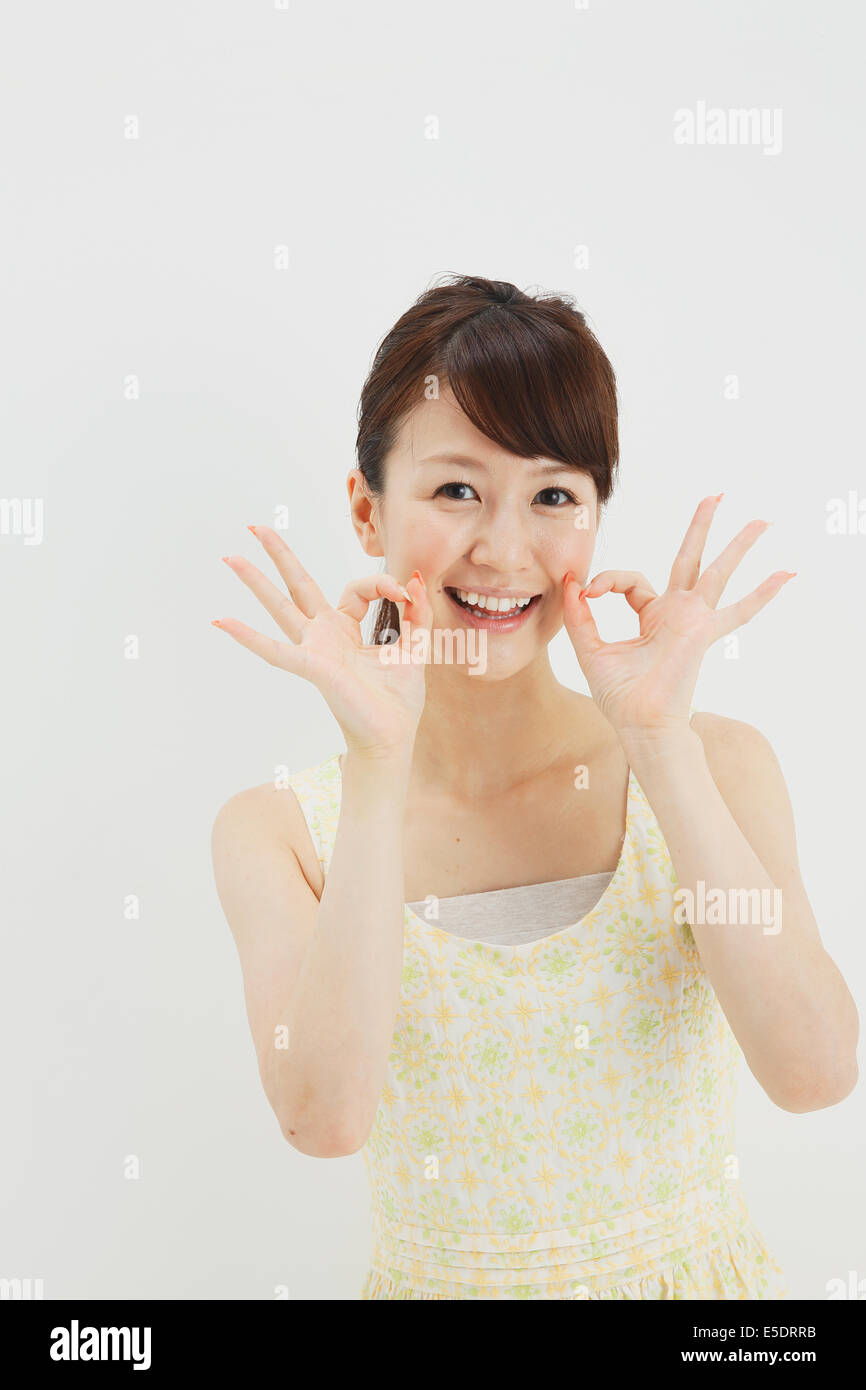 Japanese young woman in a one piece dress standing against white background Stock Photo Alamy