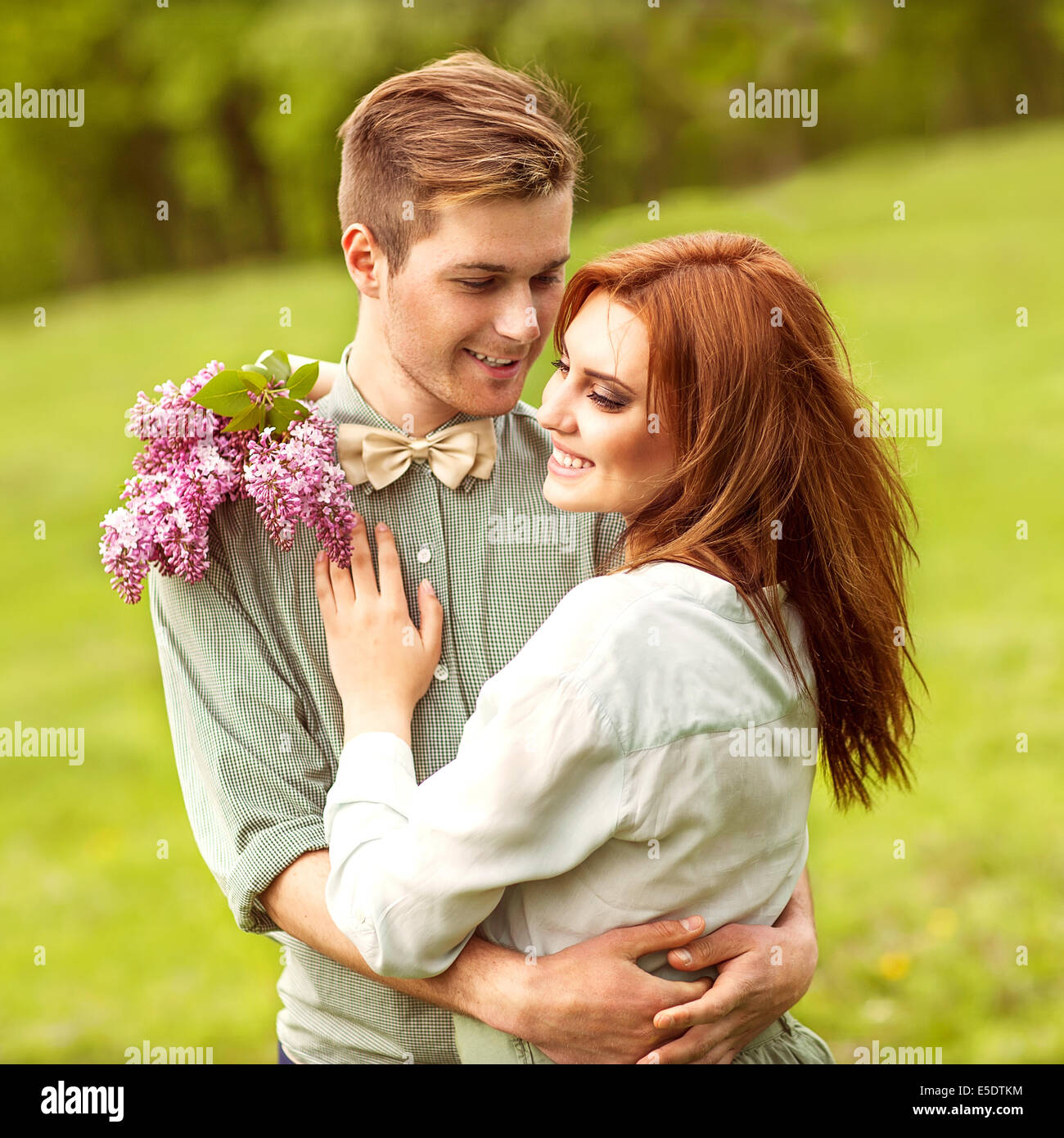 Young couple in love walking in the autumn park holding hands looking ...