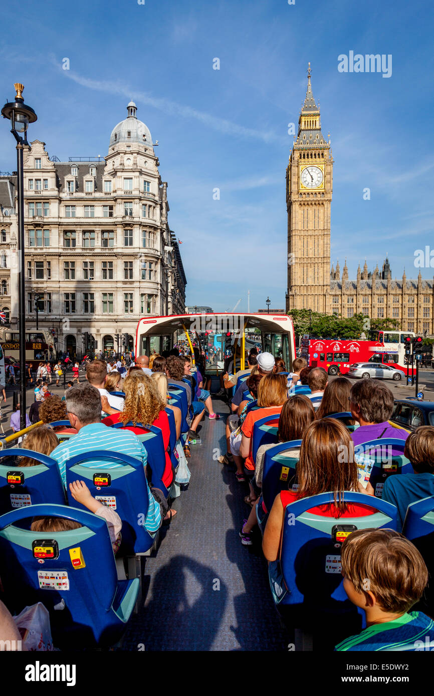 A London Tour Bus Passes By Big Ben and The Houses Of Parliament, London, England Stock Photo