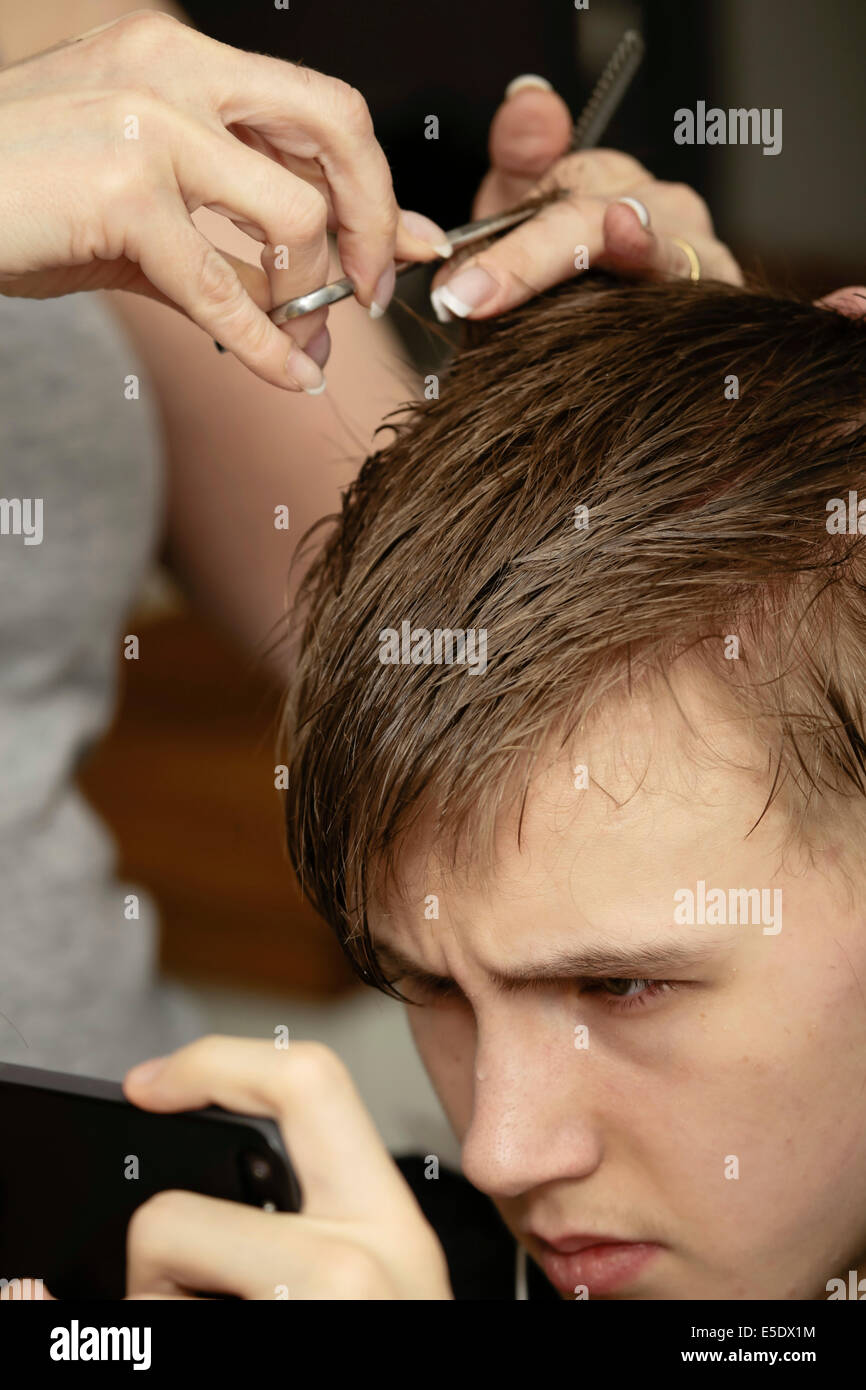 Young man having a haircut Stock Photo