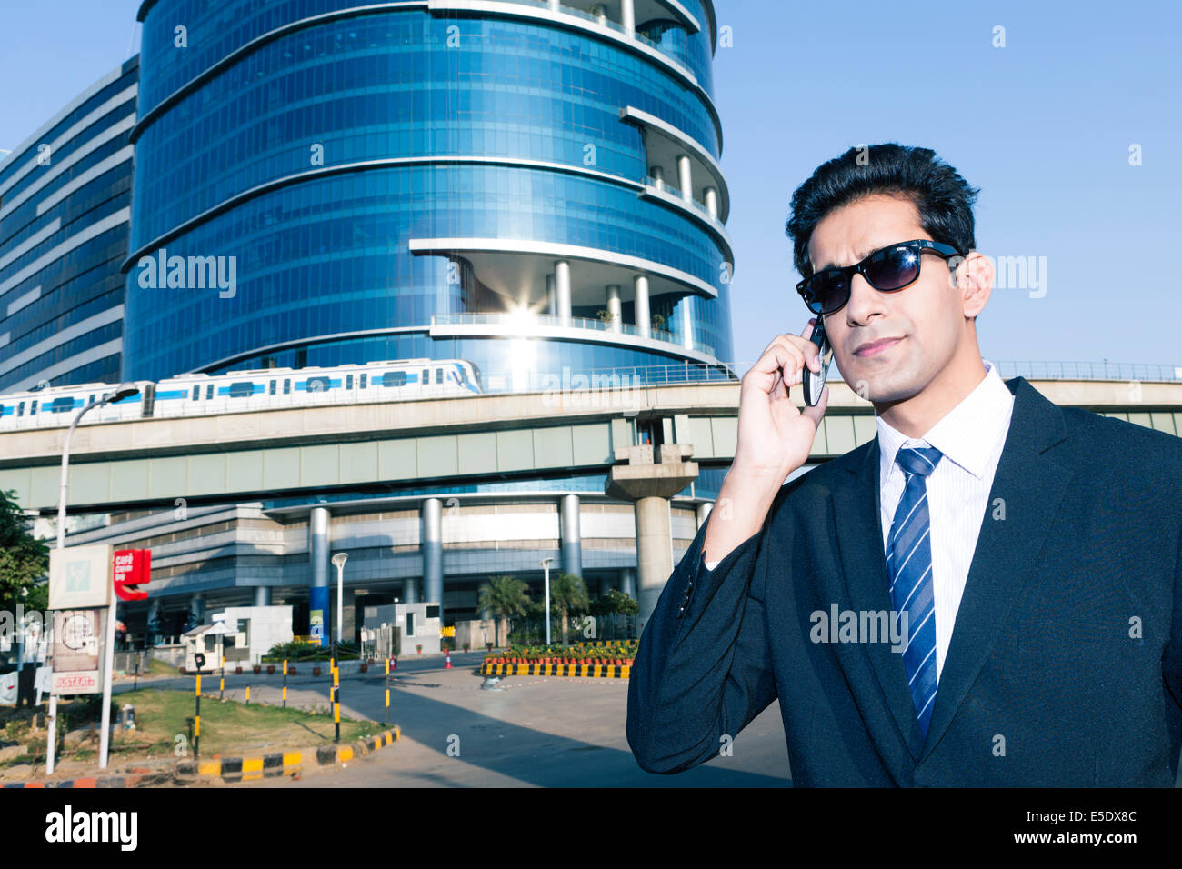 Indian business man with a mobile phone in the business sector of New Delhi, India Stock Photo