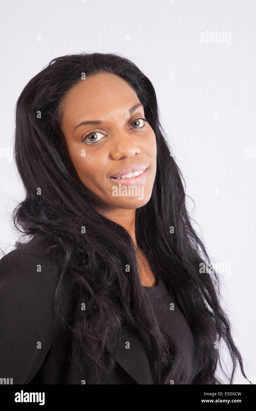 Black woman in a  black  blouse, looking at the camera with a happy expression Stock Photo