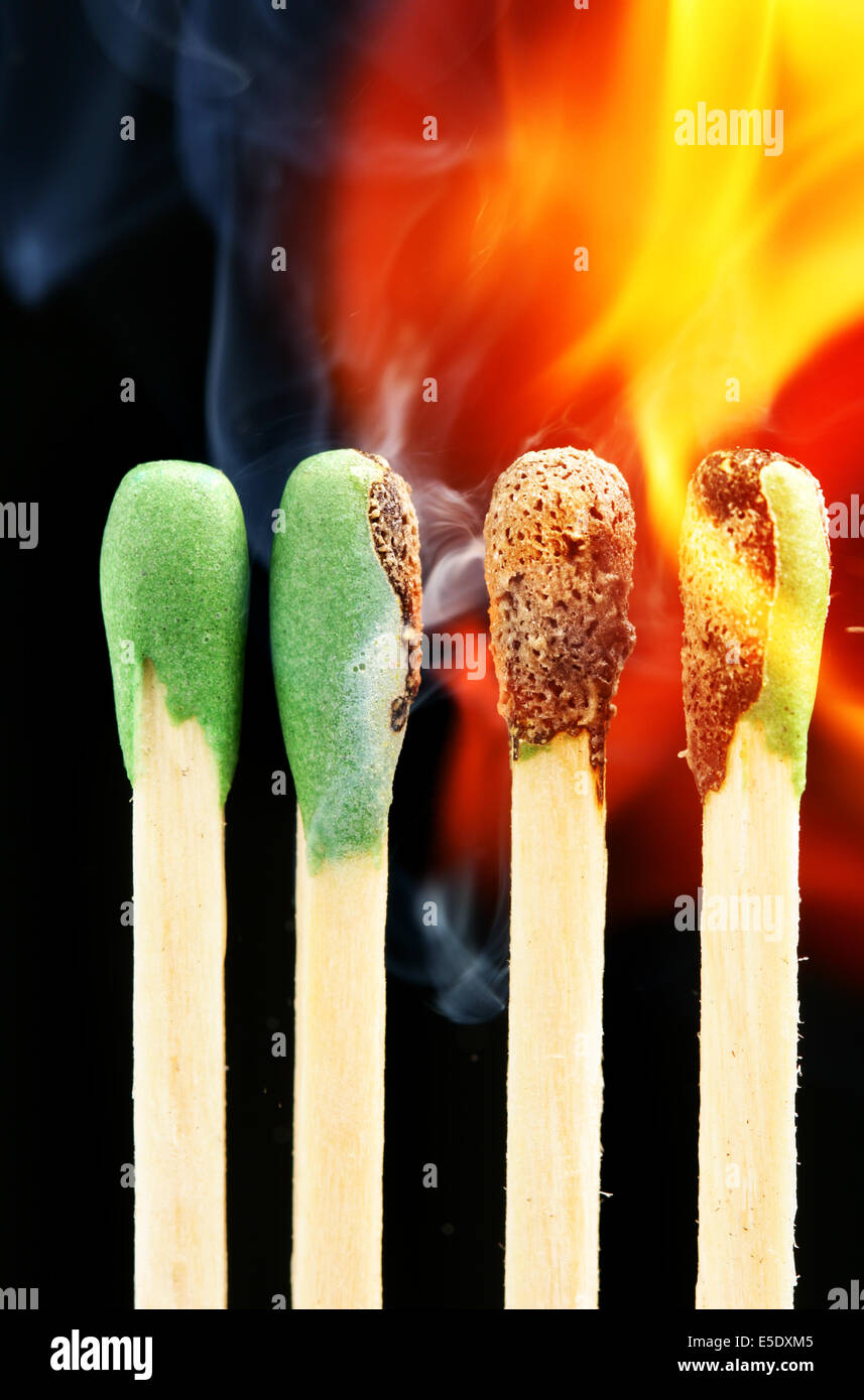 Burning matches close-up over black background (Expansion crisis concept) Stock Photo