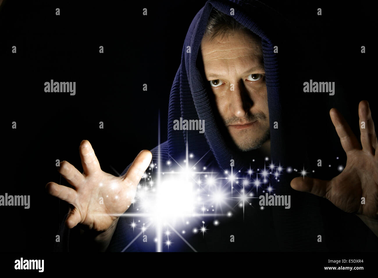 Wizard witg glowing stars between your hand Stock Photo - Alamy