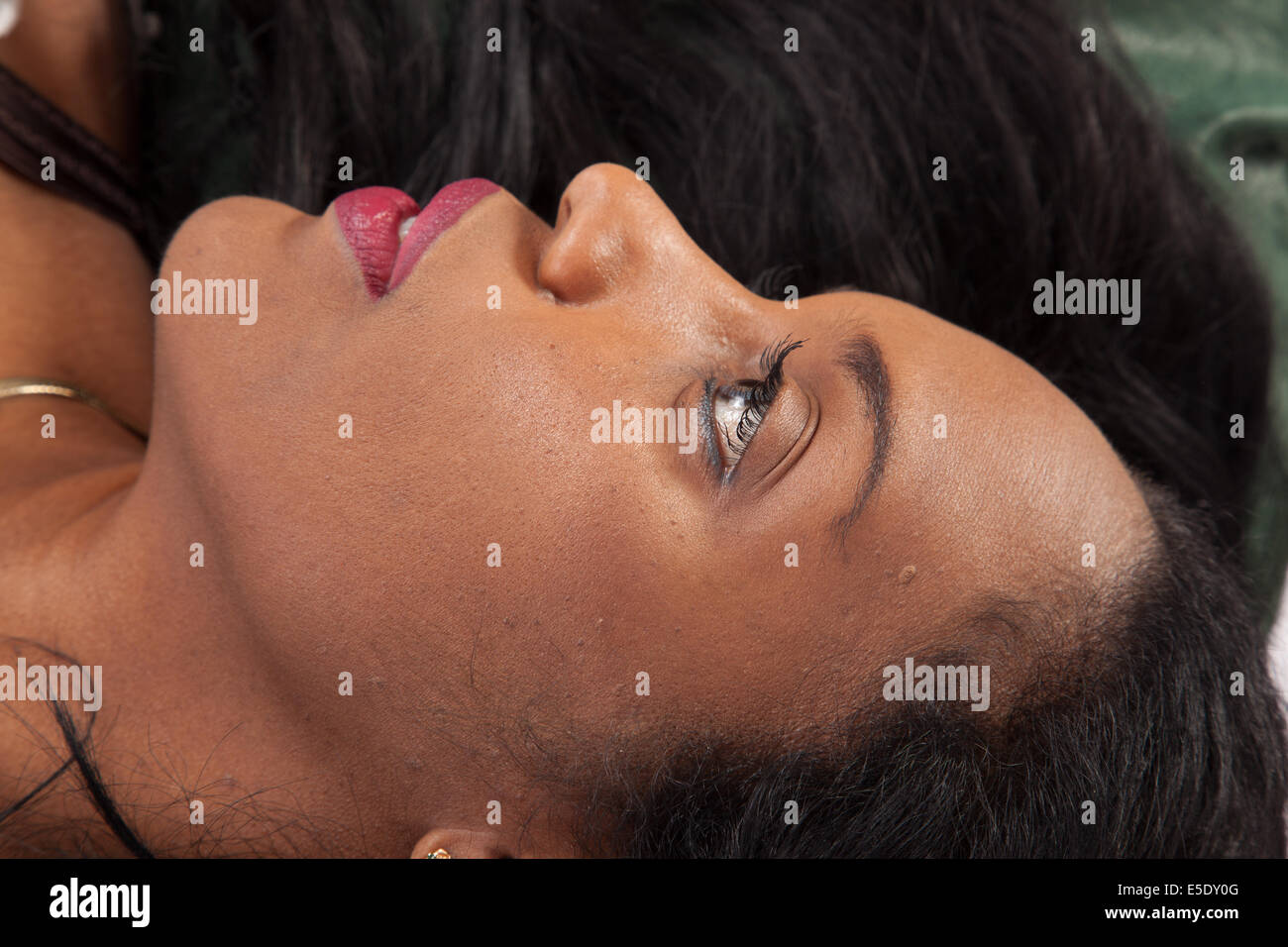 Pretty black woman reclining with a happy, pleased smile Stock Photo