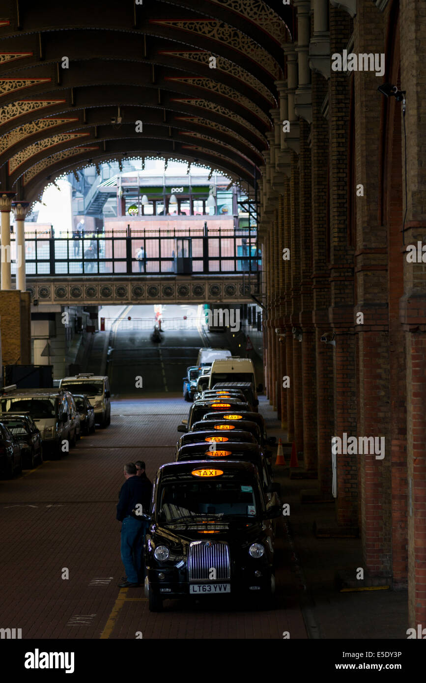 Taxis queuing up at Liverpool Street railway station to pick up passengers arriving at the
