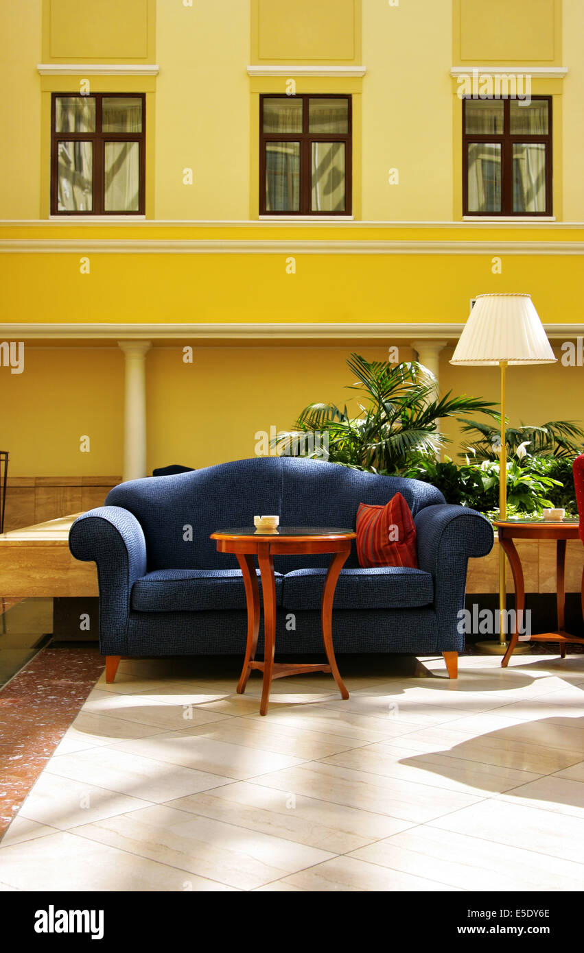 Interior of atrium with blue divan and lamp Stock Photo - Alamy