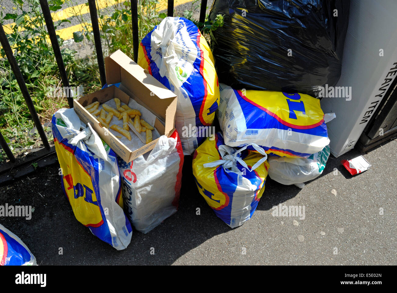 Maidstone, Kent, England. Rubbish left by a litter bin - Lidl shopping bags  Stock Photo - Alamy