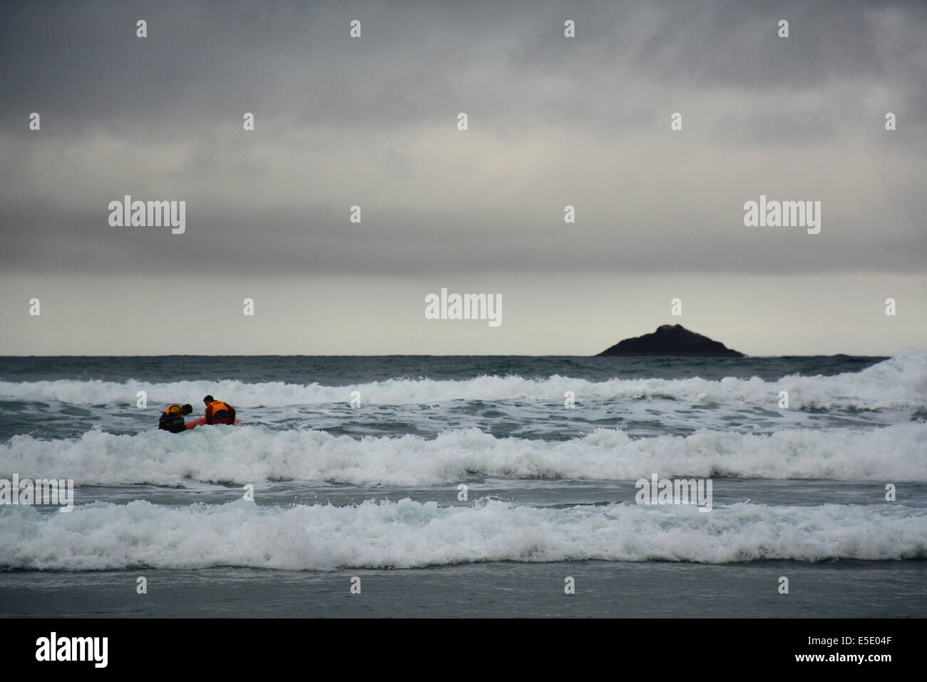 Inflatable boat with 2 lifeguards scouting the coast during Dunedin's annual midwinter Polar Plunge held at St Clair Esplanade Stock Photo