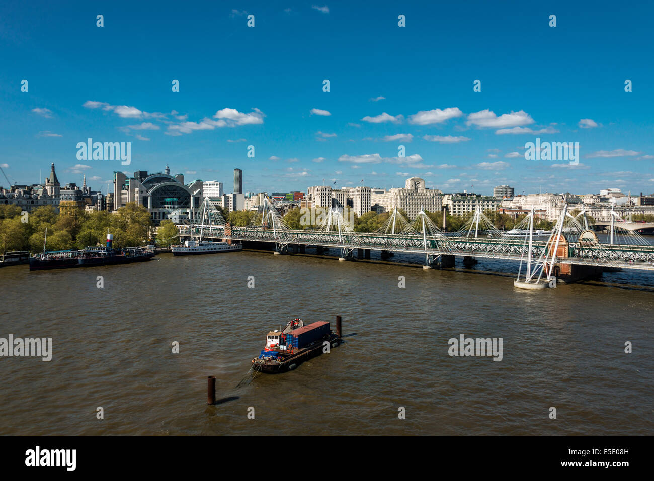 The Hungerford Bridge crosses the River Thames in London. It is a steel