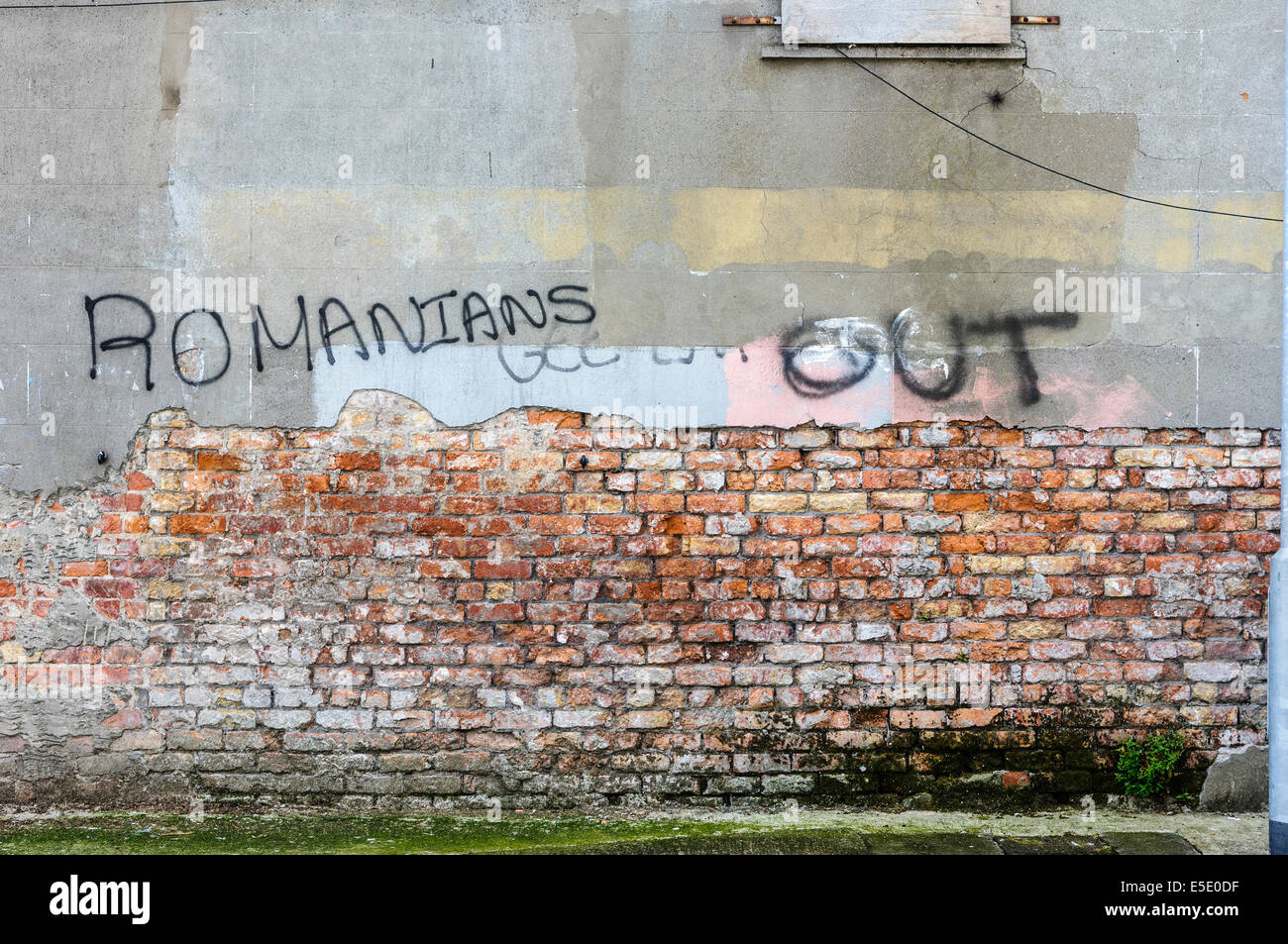 Belfast, Northern Ireland. 29th July, 2014. Graffiti saying 'Romanians Out' spraypainted  on a wall in Belfast. Credit:  Stephen Barnes/Alamy Live News Stock Photo