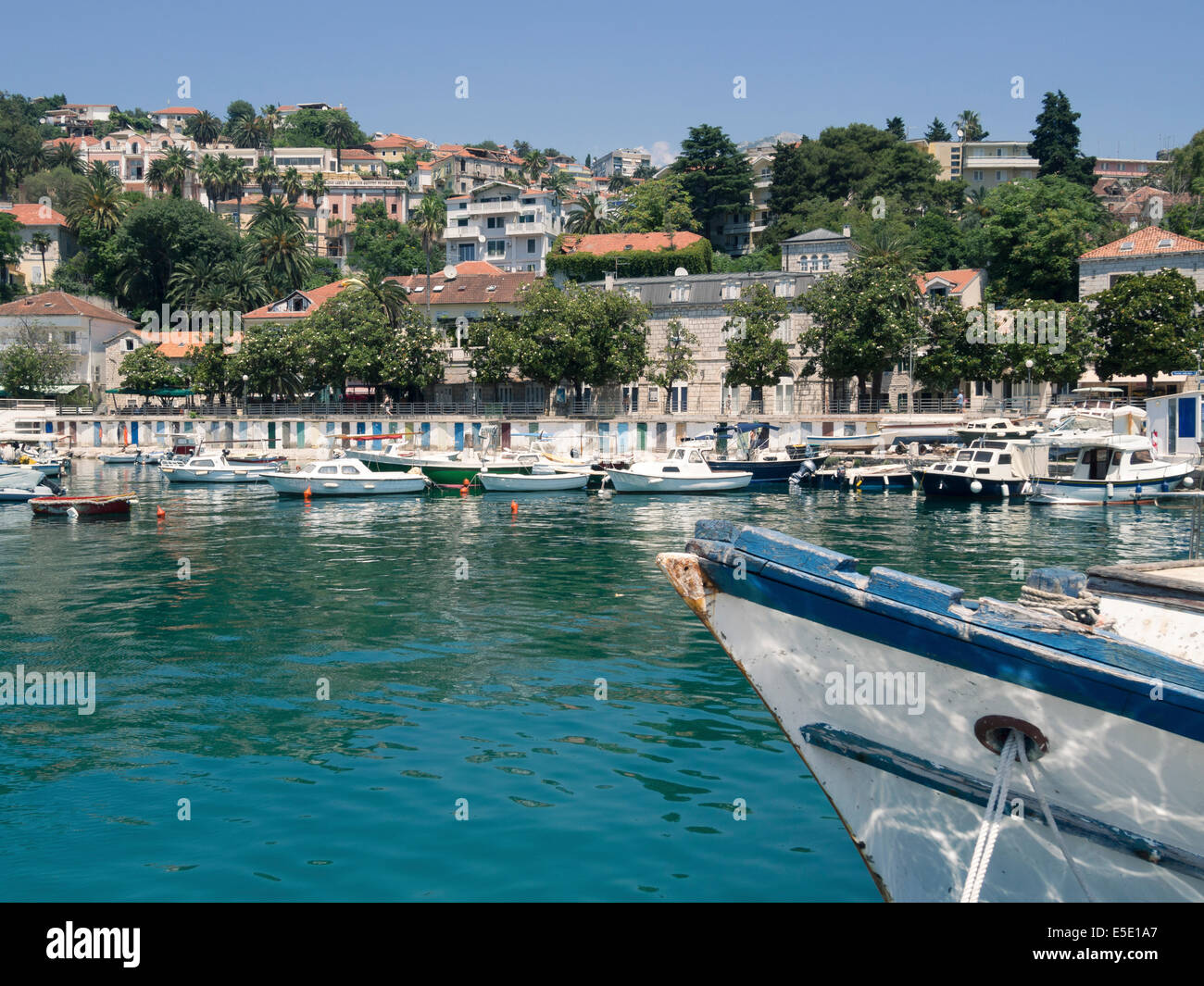 small Mediterranean port of Herceg Novi town in Montenegro with turquoise water and fishing boat nose on foreground Stock Photo