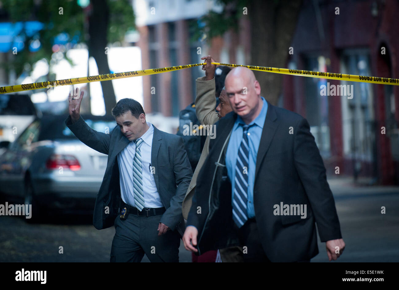 Manhattan, New York, USA. 28th July, 2014. Detectives leave the scene as two U.S. Marshals and an NYPD Detective were shot on West 4th Street near at Jones Street while trying to arrest suspected child molester Charles Mozdir, who was shot and killed, Monday, July 28, 2014. Credit:  Bryan Smith/ZUMA Wire/Alamy Live News Stock Photo