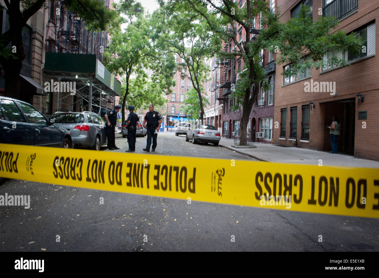 Manhattan, New York, USA. 28th July, 2014. Police tape across the scene as two U.S. Marshals and an NYPD Detective were shot on West 4th Street near at Jones Street while trying to arrest suspected child molester Charles Mozdir, who was shot and killed, Monday, July 28, 2014. Credit:  Bryan Smith/ZUMA Wire/Alamy Live News Stock Photo