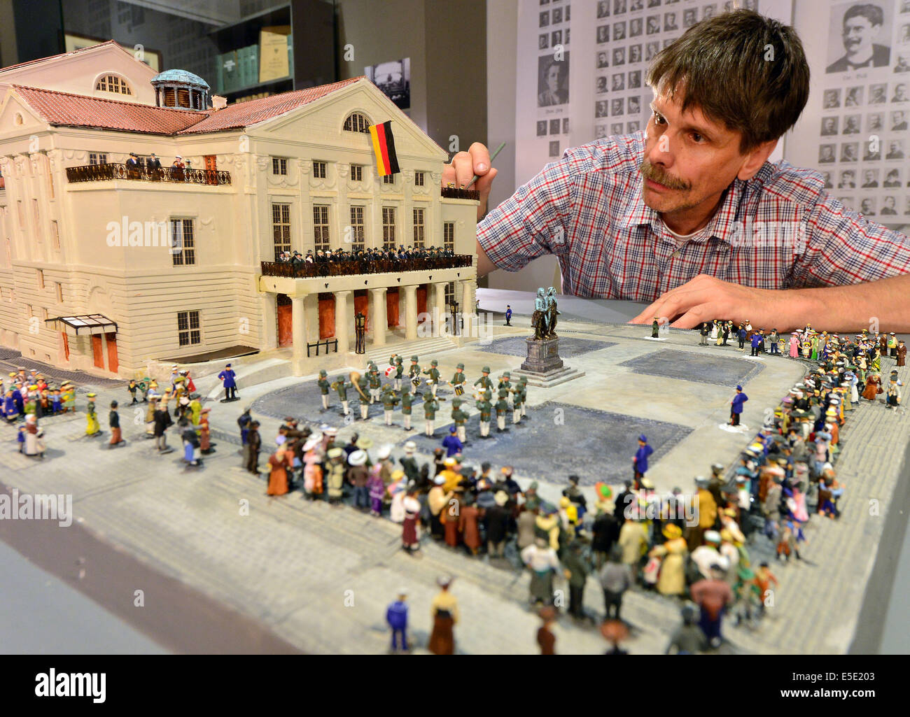 Weimar, Germany. 29th July, 2014. Plasterer Mathias Moehl works at a model of the German National Theater Weimar in the exhibition 'Democracy from Weimar. The National Assembly of 1919' in the Municipal Museum in Weimar, Germany, 29 July 2014. It shows the historic situation on Theaterplatz on 21 August 1919 after the swearing-in of Reich President Friedrich Ebert. Photo: MARTIN SCHUTT/dpa/Alamy Live News Stock Photo