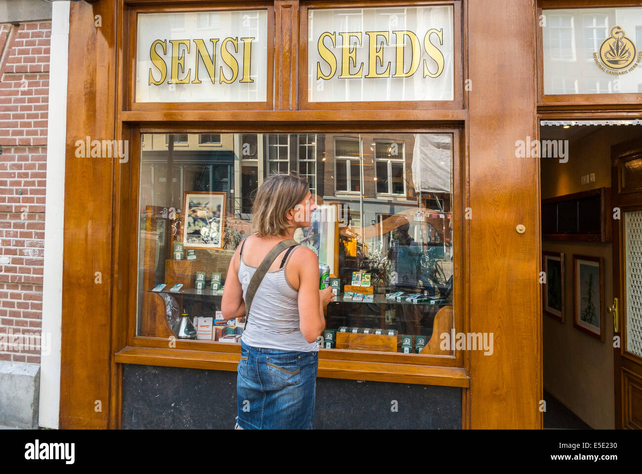 Amsterdam, Holland, The Netherlands, Female Tourist Visiting The Marijuana Museum, Store Front 'Sensi Seeds' Stock Photo