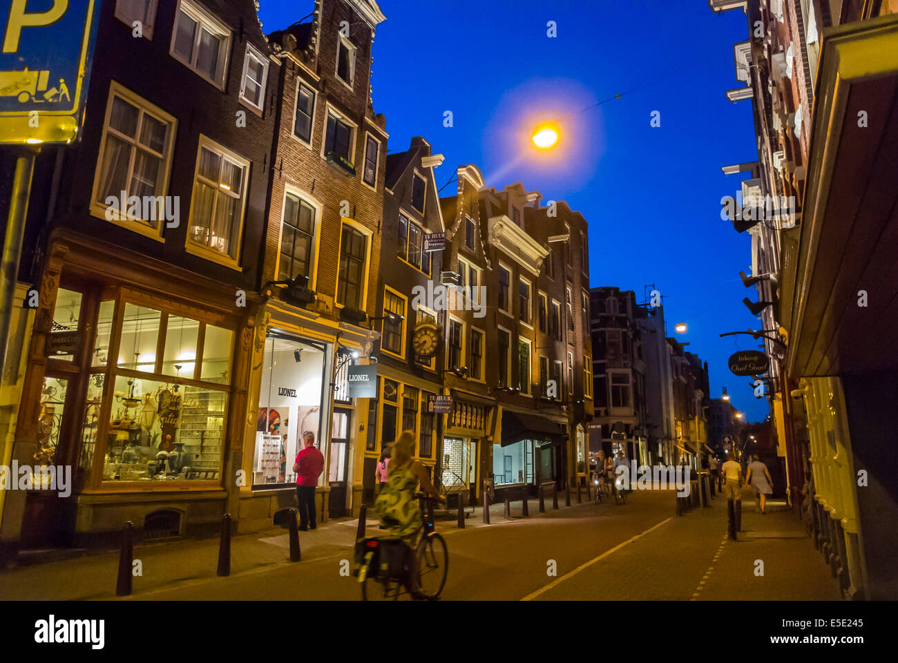 amsterdam, Holland,  The Netherlands, Street Scene at night with lighting, Local neighbourhoods, Row shops fronts Stock Photo