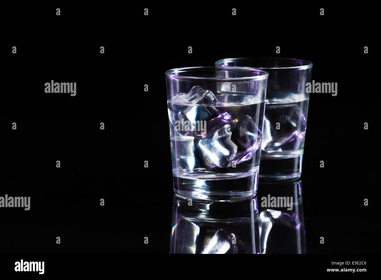 Two glasses of vodka with ice cubes Stock Photo