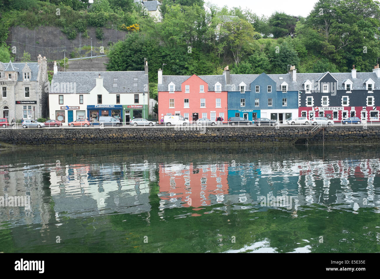 Salt water reflections of homes, Tobermory harbour, Isle of Mull, Scottish islands Stock Photo