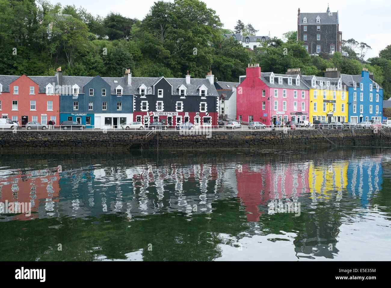 Salt water reflections of brightly painted houses, Tobermory harbour, Isle of Mull, Scottish Islands Stock Photo