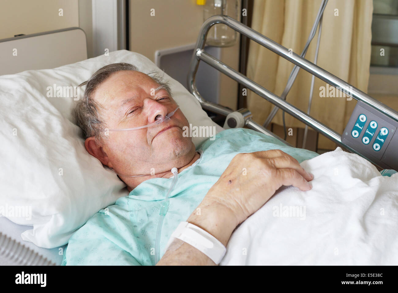 Portrait of sick old man in hospital bed Stock Photo