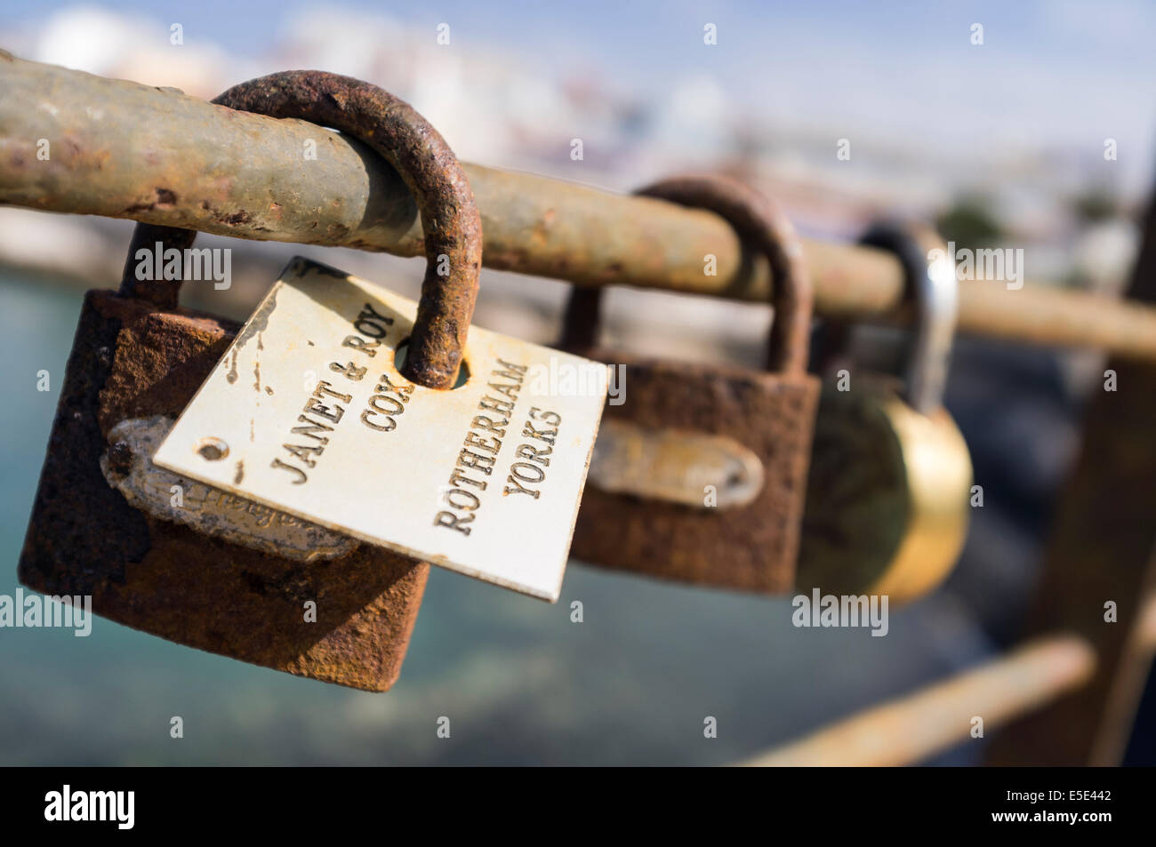 Padlocks on a railing put there by lovers as a symbol of everlasting love. La caleta, tenerife, canary islands, Spain. Stock Photo