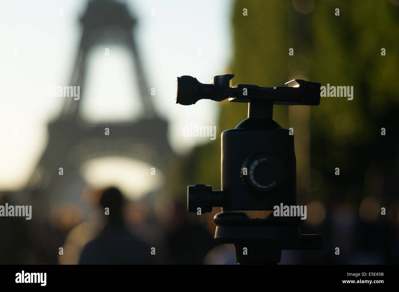 Photographer setting up tripod in front of Eiffel Tower waiting for the fireworks on Bastille Day French National Holiday Stock Photo