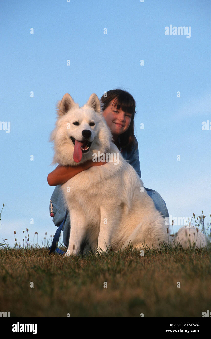 Beautiful young girl posing with pet dog. Stock Photo