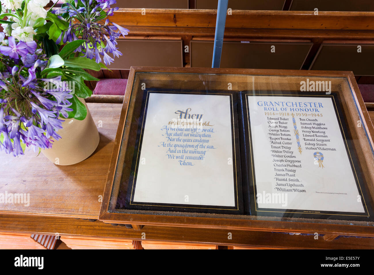 The interior of the parish church at Grantchester, Cambridgeshire UK showing Rupert Brooke's name on the Roll of Honour Stock Photo