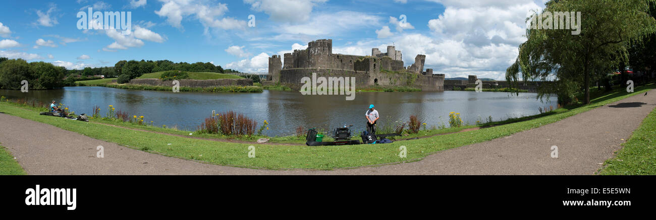 Panorama of Caerphilly Castle and it's famous leaning tower, Mid Glamorgan, South Wales, UK on a summers day with fisherman. Stock Photo