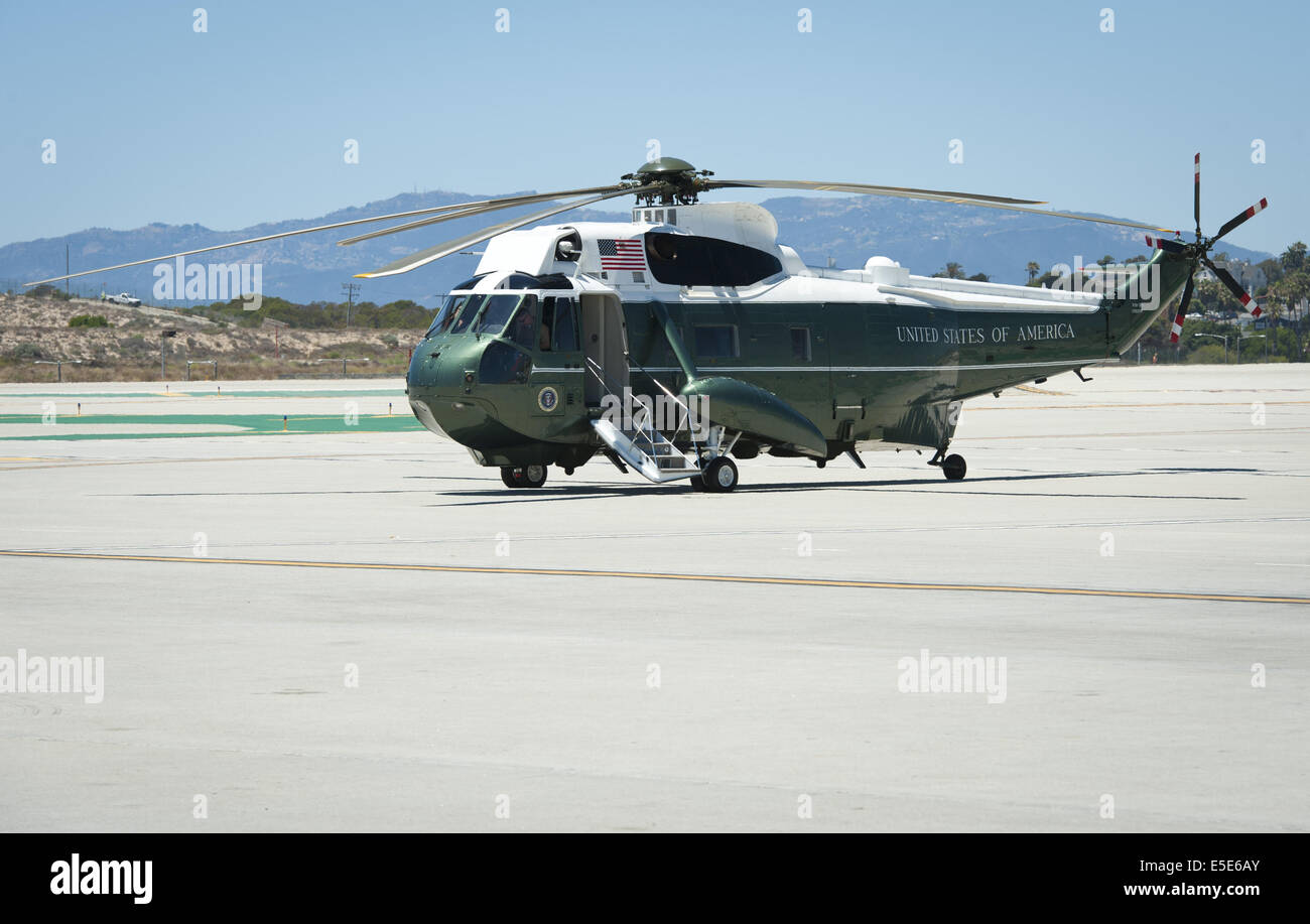 July 23, 2014 - Los Angeles, California, U.S - Marine One --- Marine One on the tarmac at LAX on Wednesday July 23, 2014.  Sikorsky's SH-3 Sea King helicopter has been in use by the US Marine Corps' HMX-1 squadron as the first choice for Marine One since not long after it was placed in service by the US Navy in 1961.  The familiar metallic green with white top Sea King is transported, along with the presidential limousine and other large equipment via a set of several C-17 Boeing Globemaster transport aircraft operated by the US Air Force.  US Navy specifications allow for the rotors to fold b Stock Photo