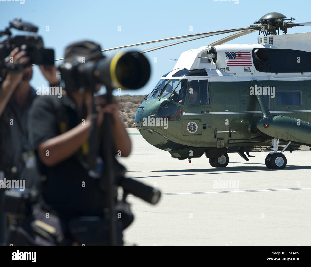 July 23, 2014 - Los Angeles, California, U.S - Marine One --- Marine One on the tarmac at LAX on Wednesday July 23, 2014, alongside news photographers waiting for the arrival of President Barack Obama.  Sikorsky's SH-3 Sea King helicopter has been in use by the US Marine Corps' HMX-1 squadron as the first choice for Marine One since not long after it was placed in service by the US Navy in 1961.  The familiar metallic green with white top Sea King is transported, along with the presidential limousine and other large equipment via a set of several C-17 Boeing Globemaster transport aircraft oper Stock Photo