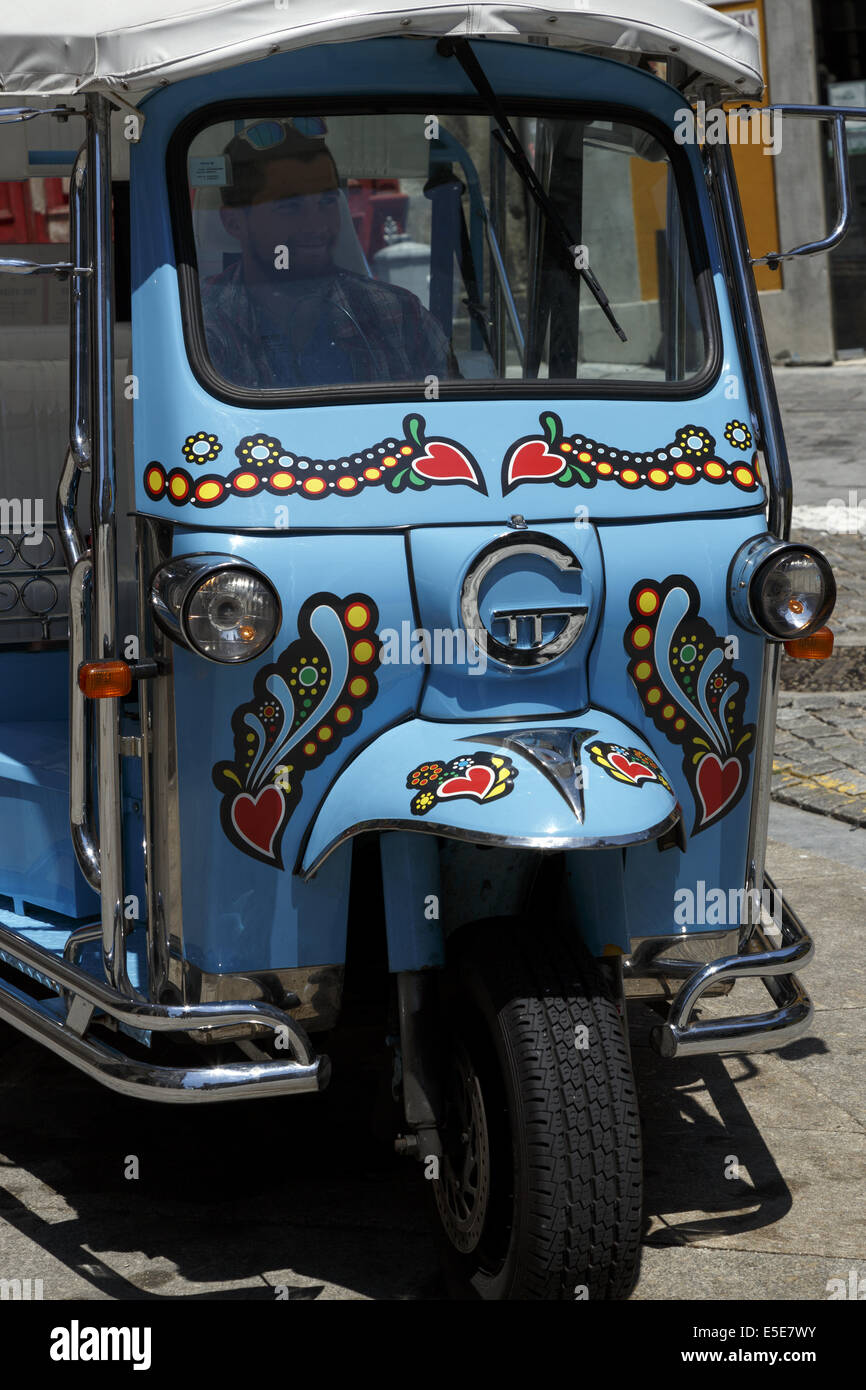 Colourful Three wheeled electric tuk tuk on the streets of Porto Portugal Stock Photo