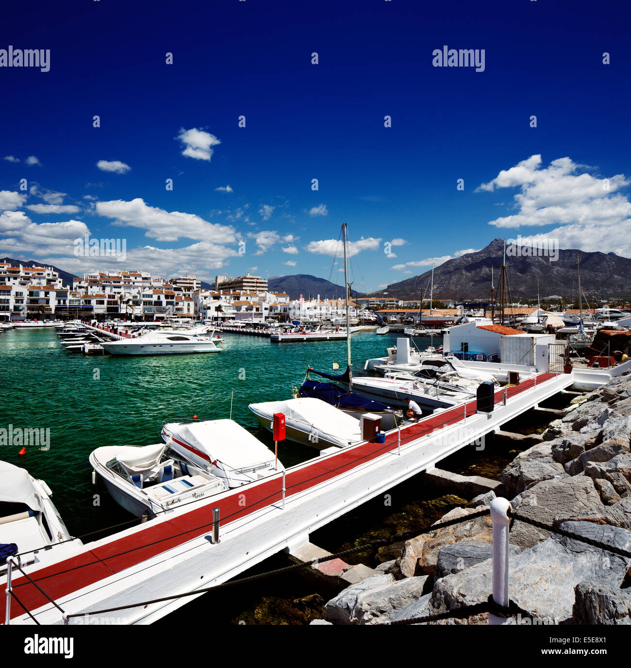 Motor launch/boat moored in Puerto Banus marina near Marbella Costa del Sol  Spain with white apartments in background Stock Photo - Alamy