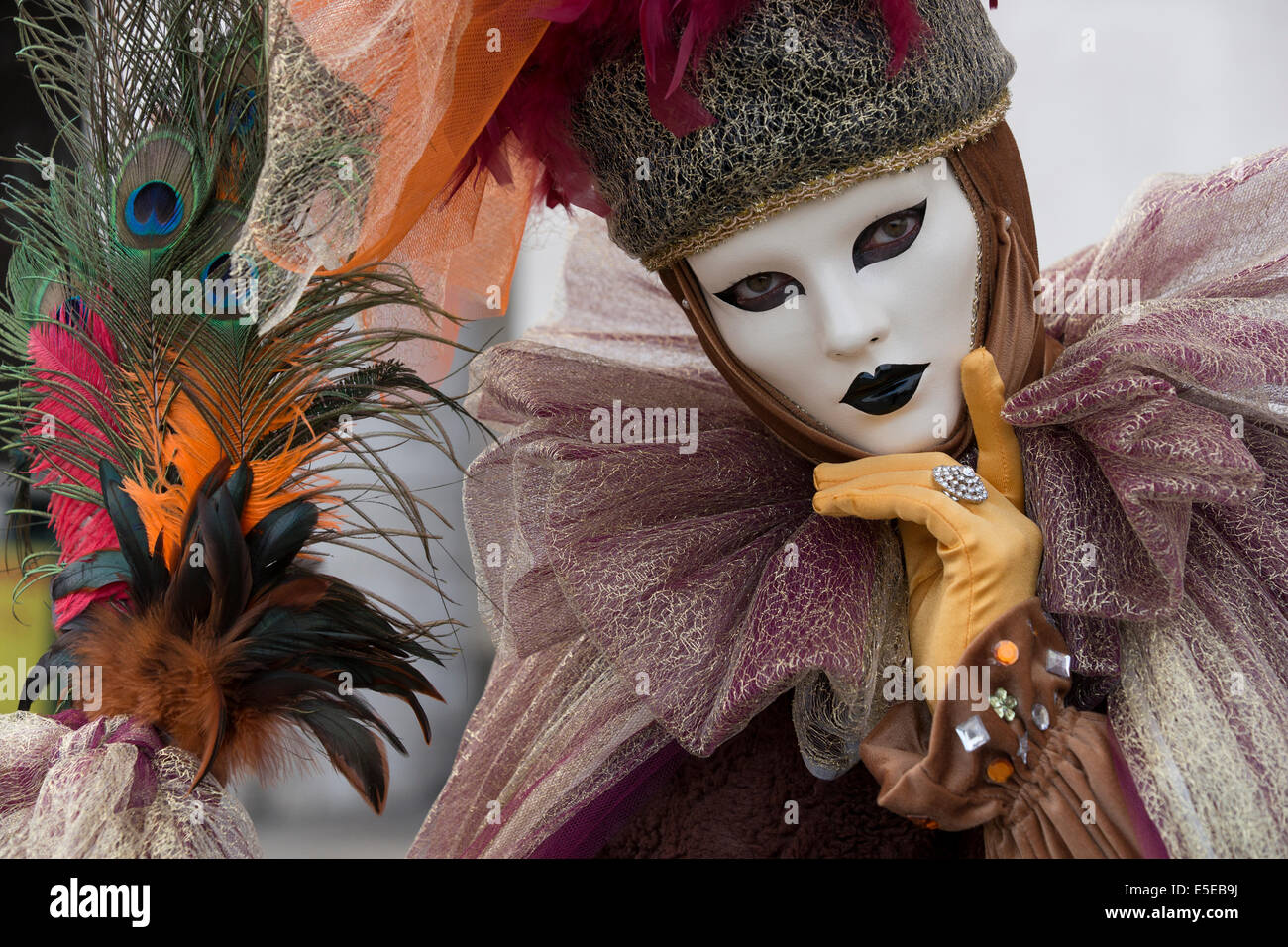 Woman in frilly lace costume and mask celebrates Carnival in Venice. Stock Photo