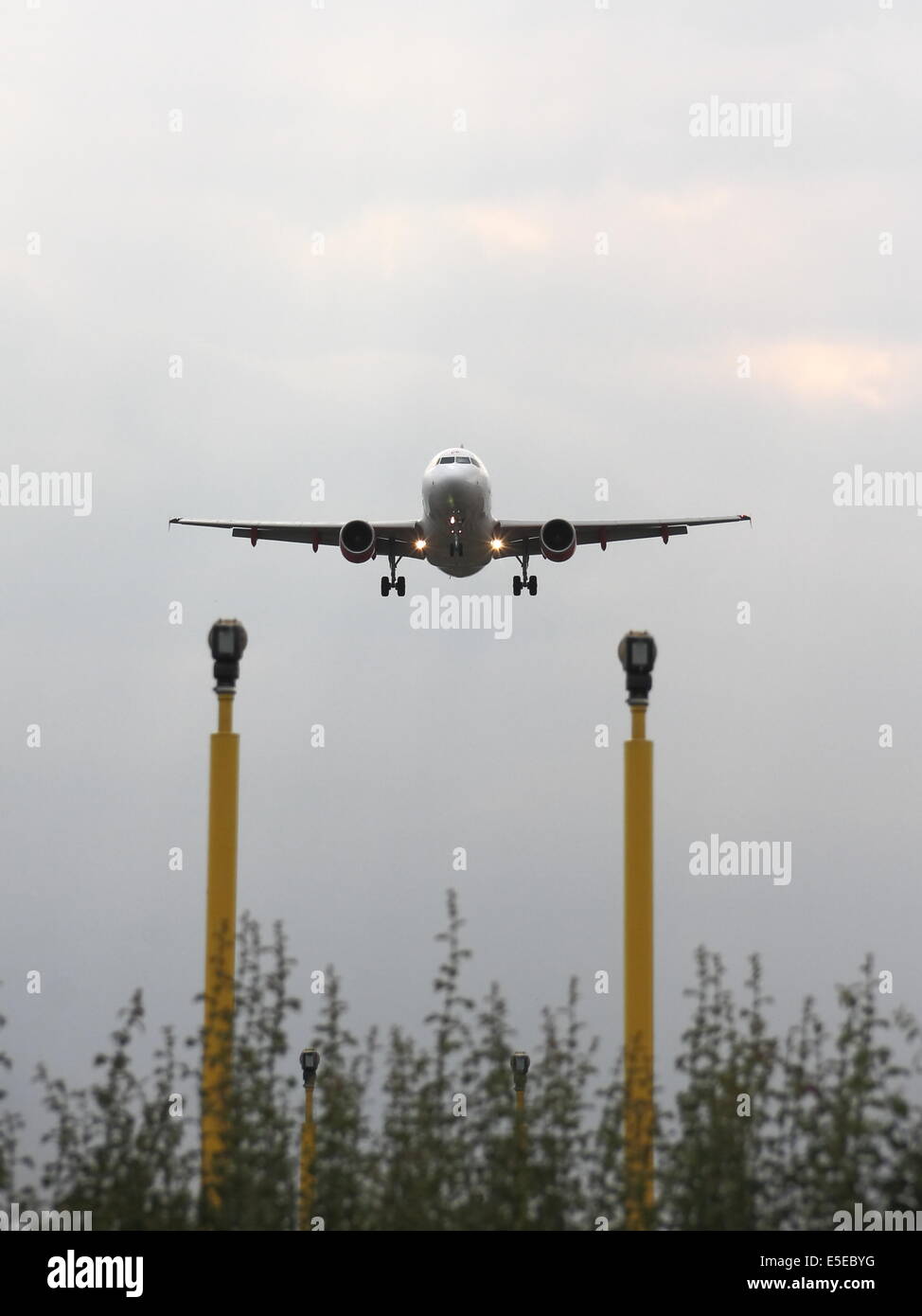An EasyJet airbus A319 lining up on the runway alignment markers, preparing to land. Stock Photo