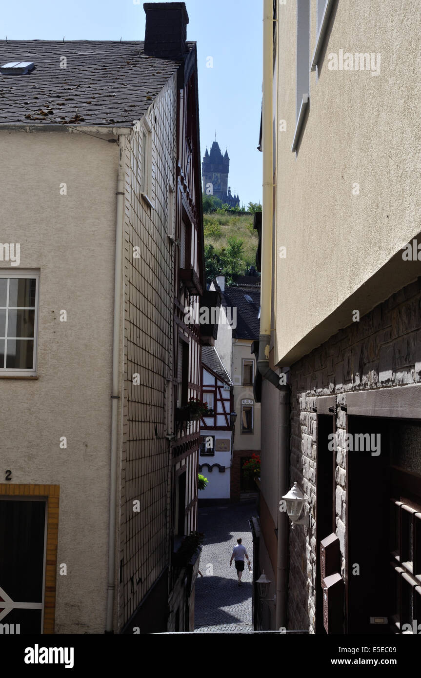 Cochem Imperial Castle, or Reichsburg, is glimpsed between buildings in the town of Cochem on the Moselle River, Germany Stock Photo