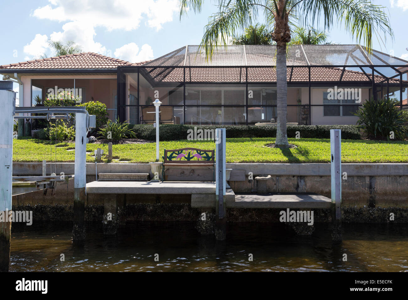 Luxury Residential Canal Front Home with Screened in Pool Deck and