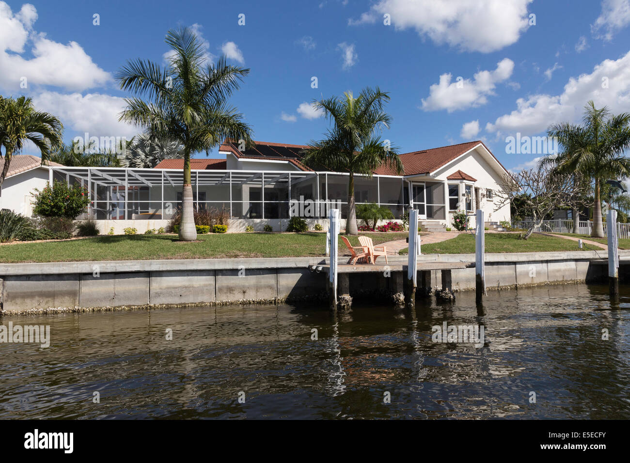Luxury Residential Canal Front Home with Screened in Pool Deck and