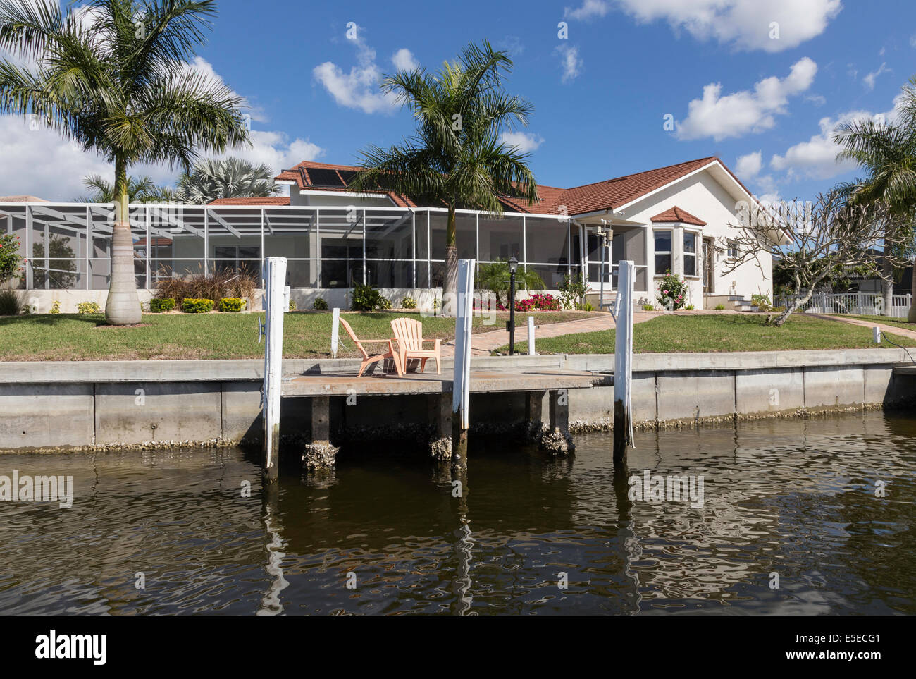 Luxury Residential Canal Front Home with Screened in Pool Deck and