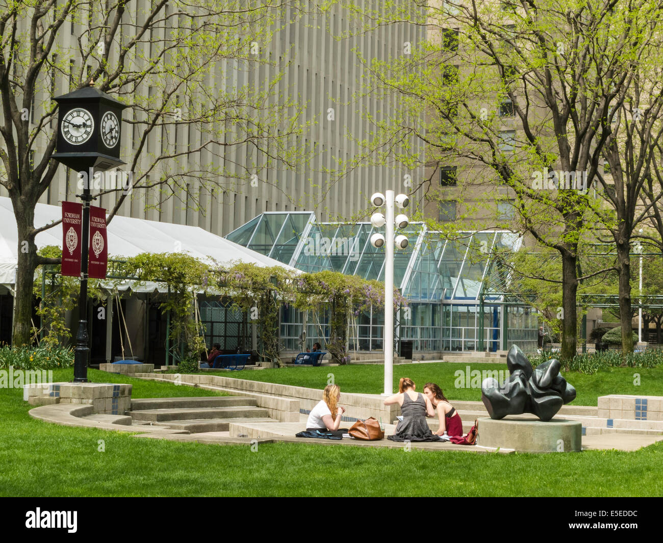 Students Talking and Studying, Fordham University, Lincoln Center Campus Grounds in Springtime, NYC, USA Stock Photo