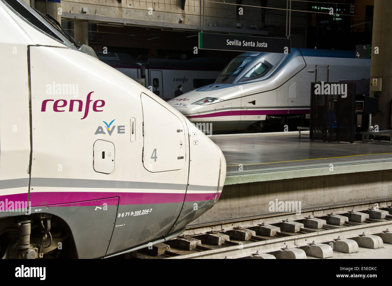 Two Ave high-speed trains wait at their platform at Seville's Santa Justa train station. Stock Photo