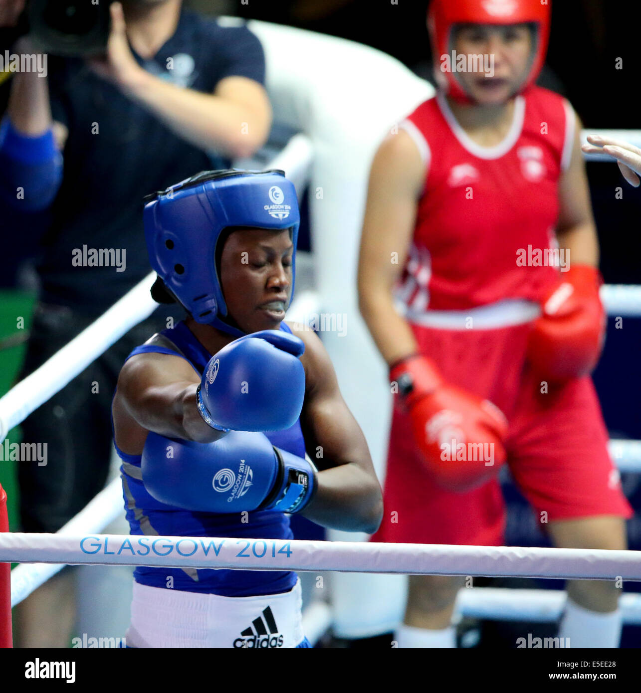 SECC Glasgow Scotland 29 Jul 2014. Commonwealth Games day 6. Men's and Women's boxing rounds. Laishram Devi IND beats Kehinde Obarah NGR in Women's light final 16 round after bout was stopped when Obarah suffers a shoulder injury. Credit:  ALAN OLIVER/Alamy Live News Stock Photo